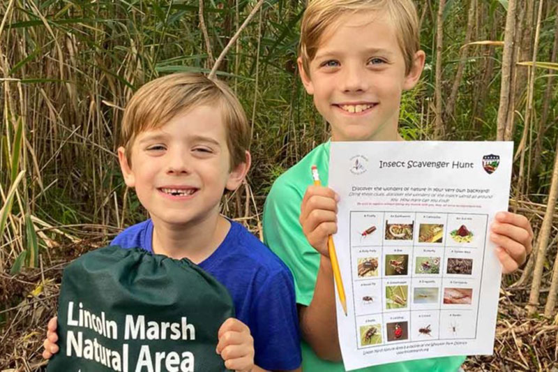 2 boys showing Nature to go kit